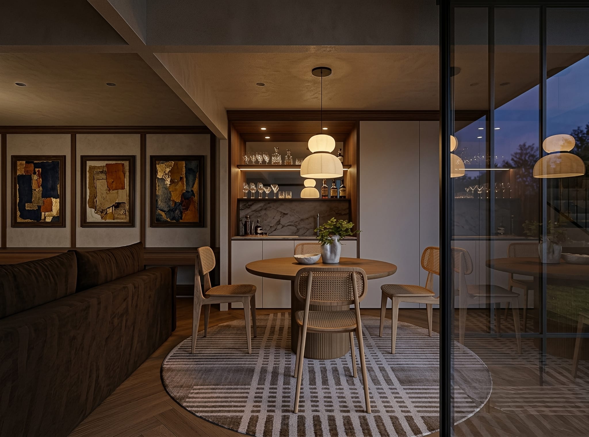 Evening dining setting with cane chairs on a striped round rug, a built-in bar with marble backsplash and abstract artworks above a velvet sofa.